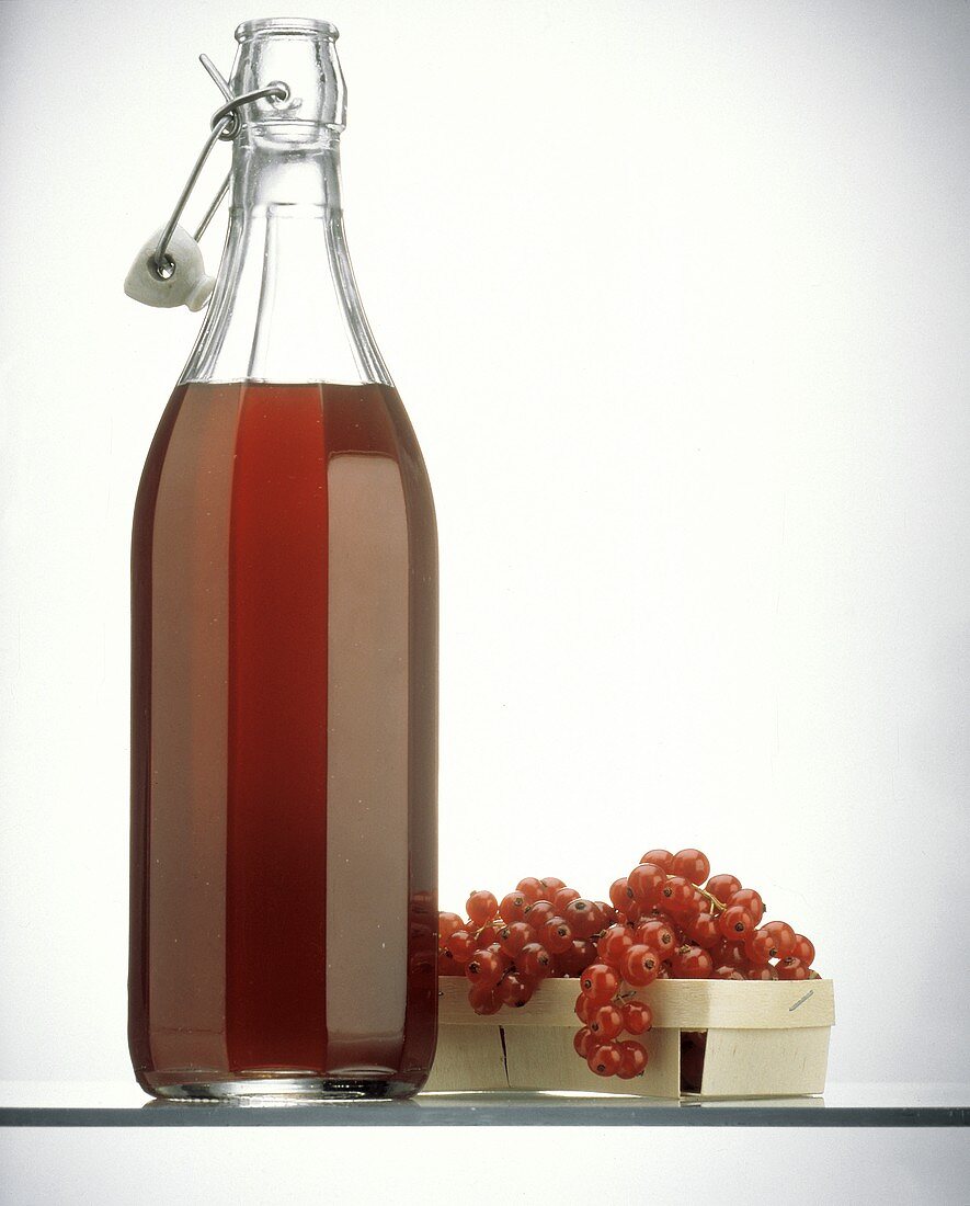 A Bottle of Currant Juice with Fresh Currants