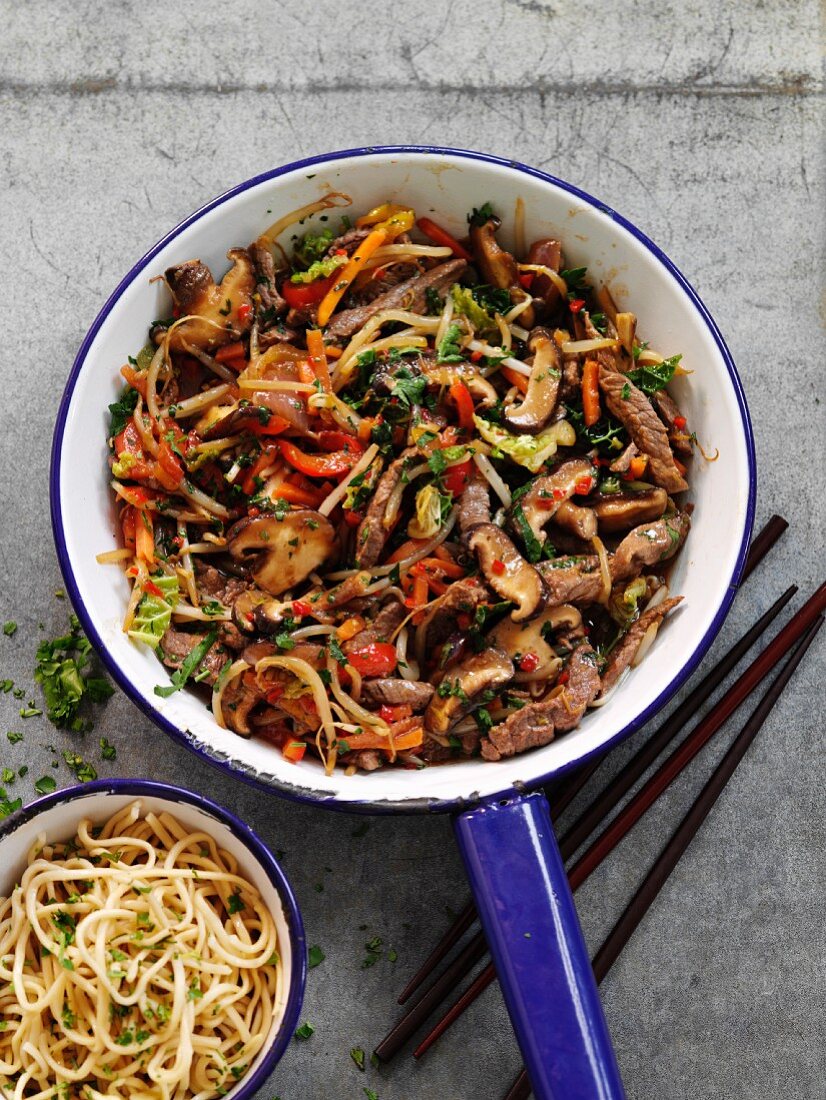 Quick and easy beef stir fry with vegetables served with a side dish of noodles
