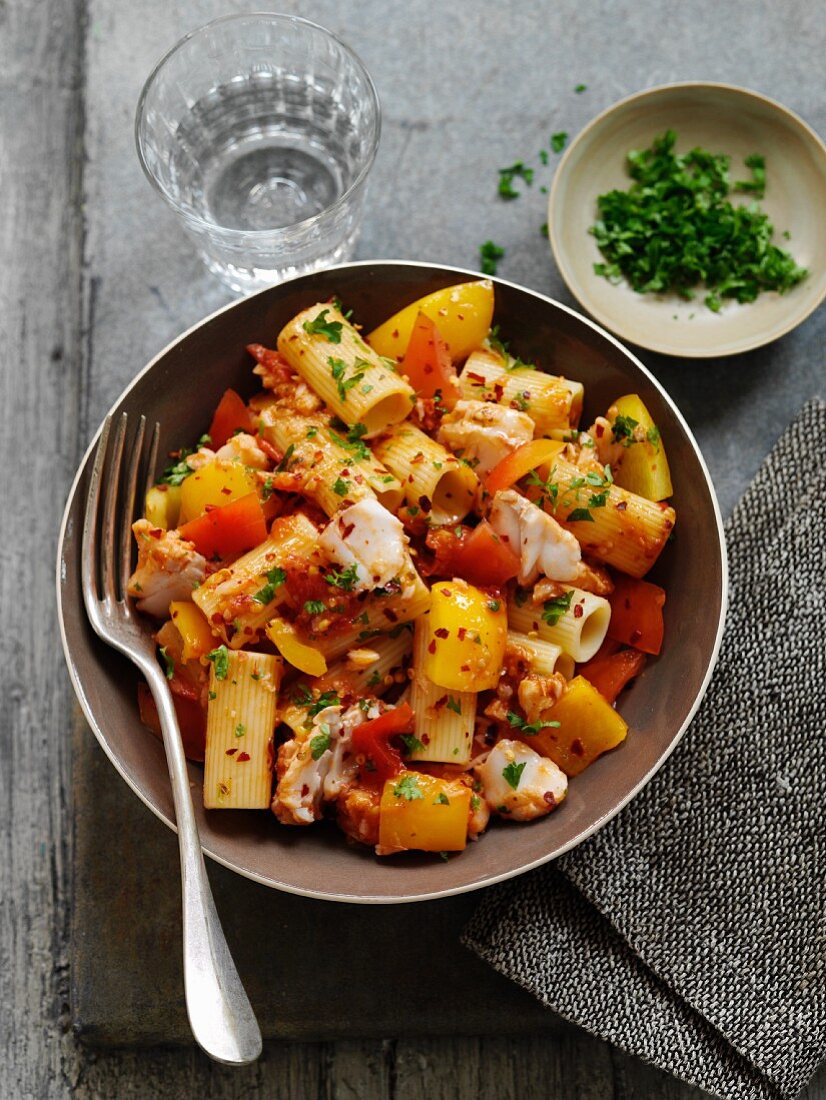 Warm rigatoni salad with hake and red and yellow pepper