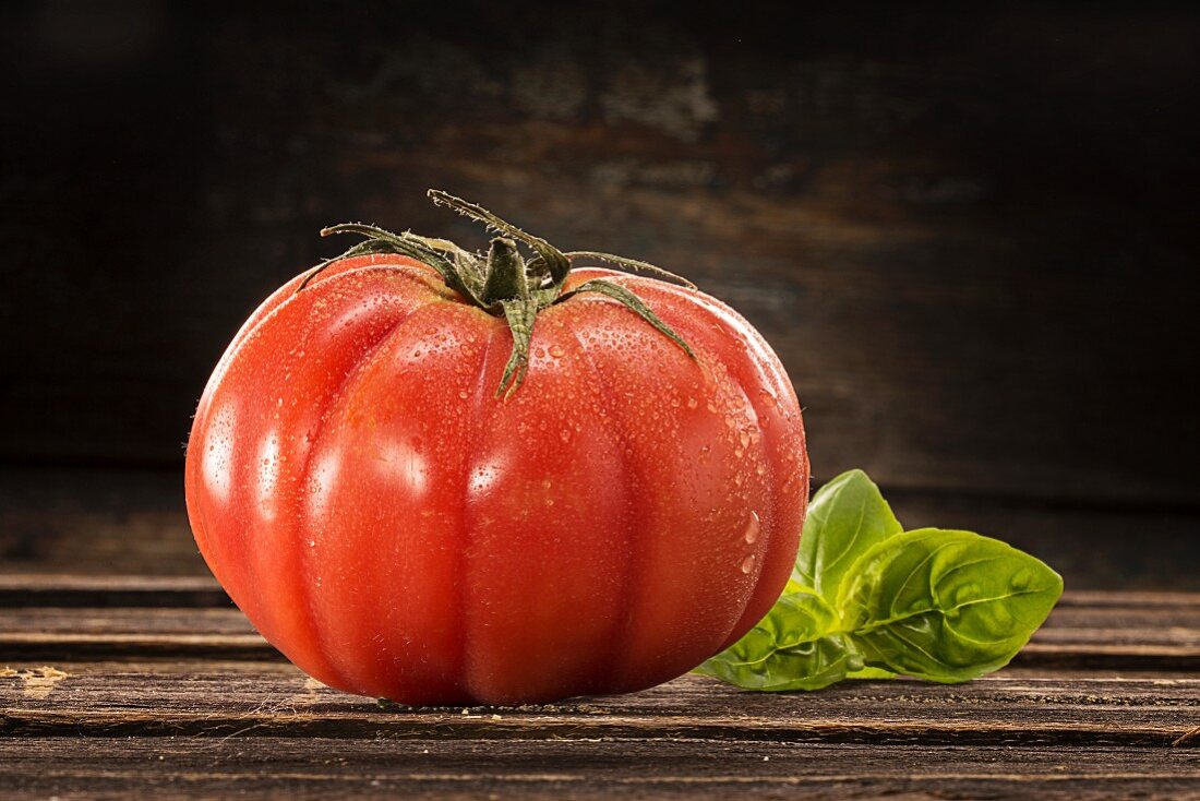 A beefsteak tomato with water droplets