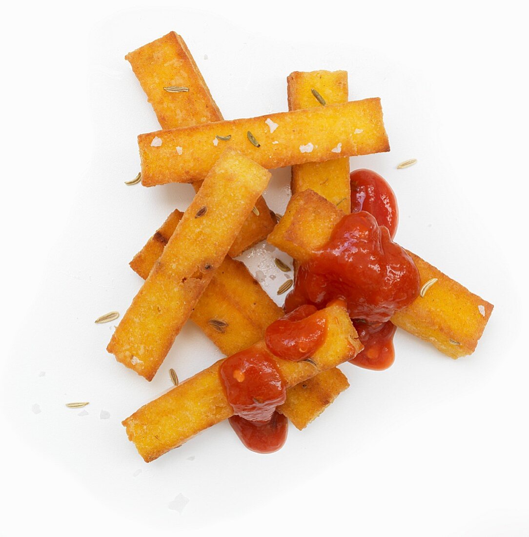 Polenta chips with tomato ketchup (seen from above)