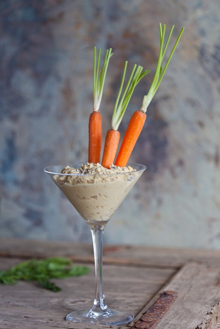 Hummus with carrots in a long-stem cocktail glass