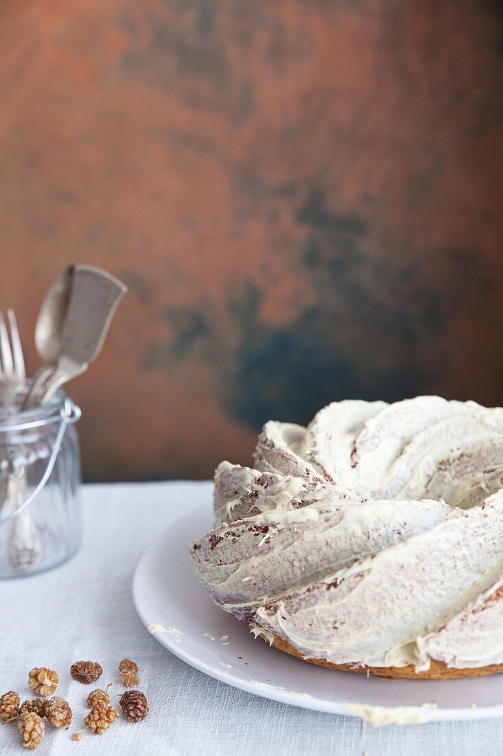 A ring-shaped Bundt cake covered in white chocolate