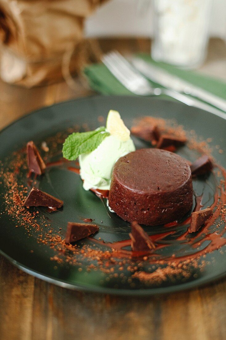 A small chocolate cake with mint ice cream