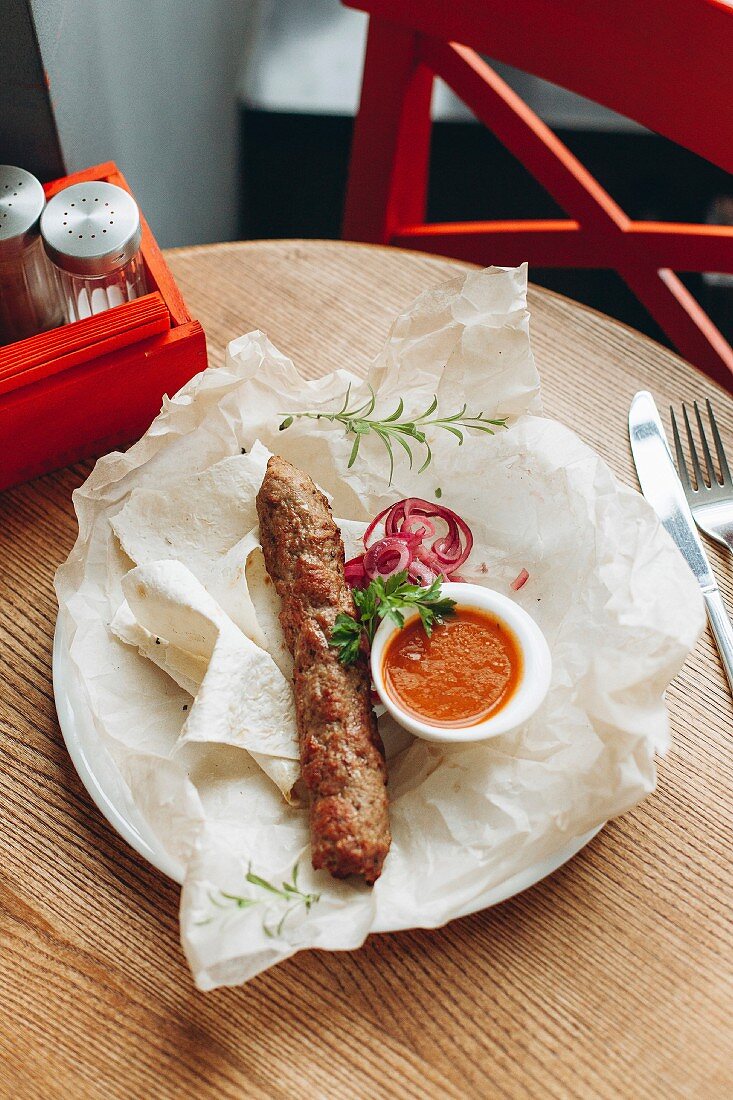 Cevapcici (minced meat skinless sausage) with flatbread and dip