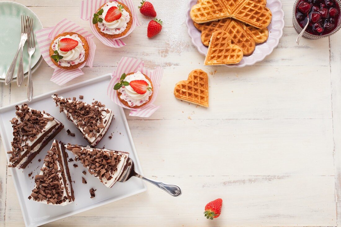 Various cakes and heart-shaped waffles