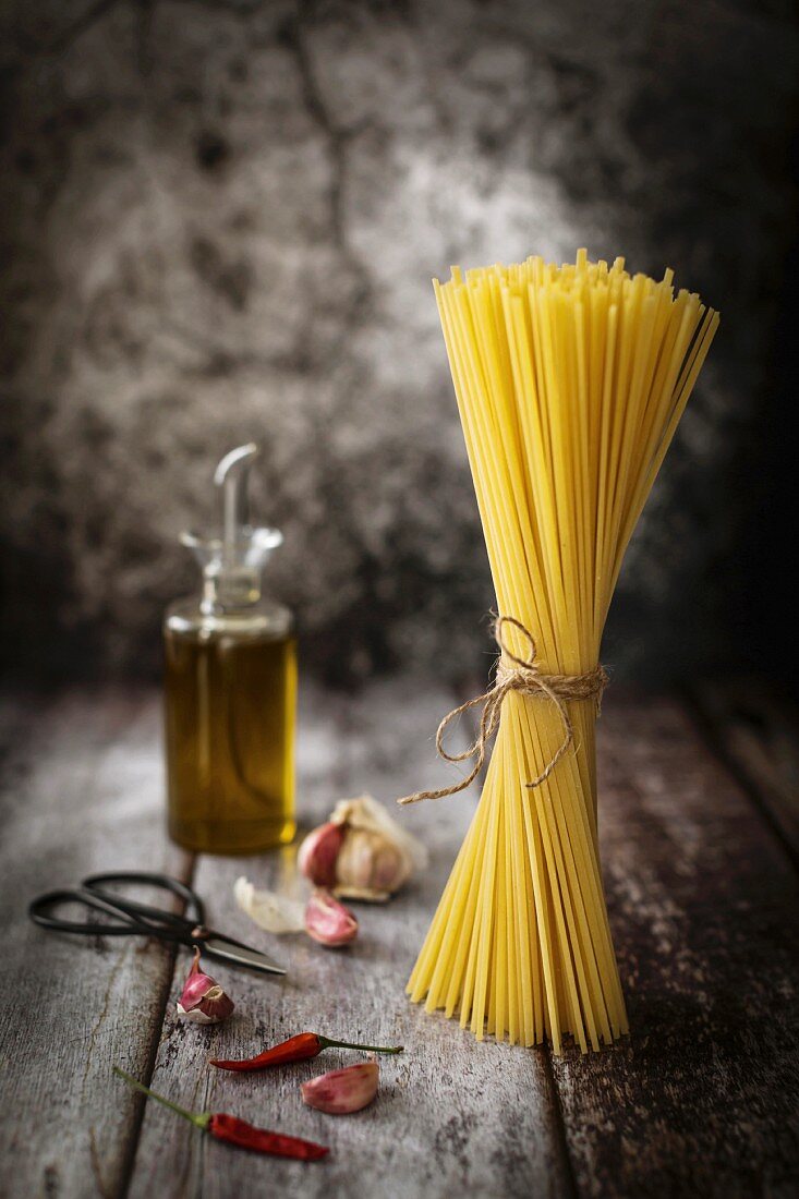 Tied dried spaghetti pasta on a rustic background