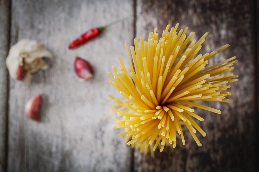 Tied dried spaghetti pasta on a rustic background