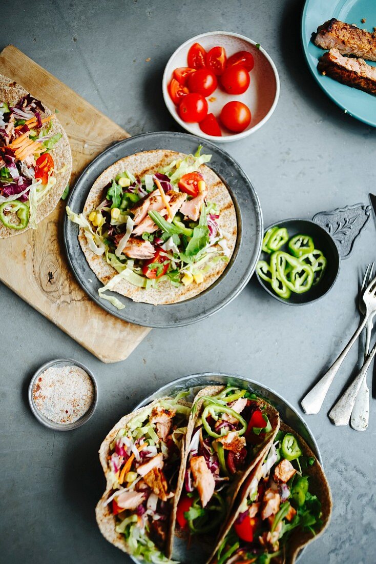 Ingredients for salmon tacos on the concrete floor