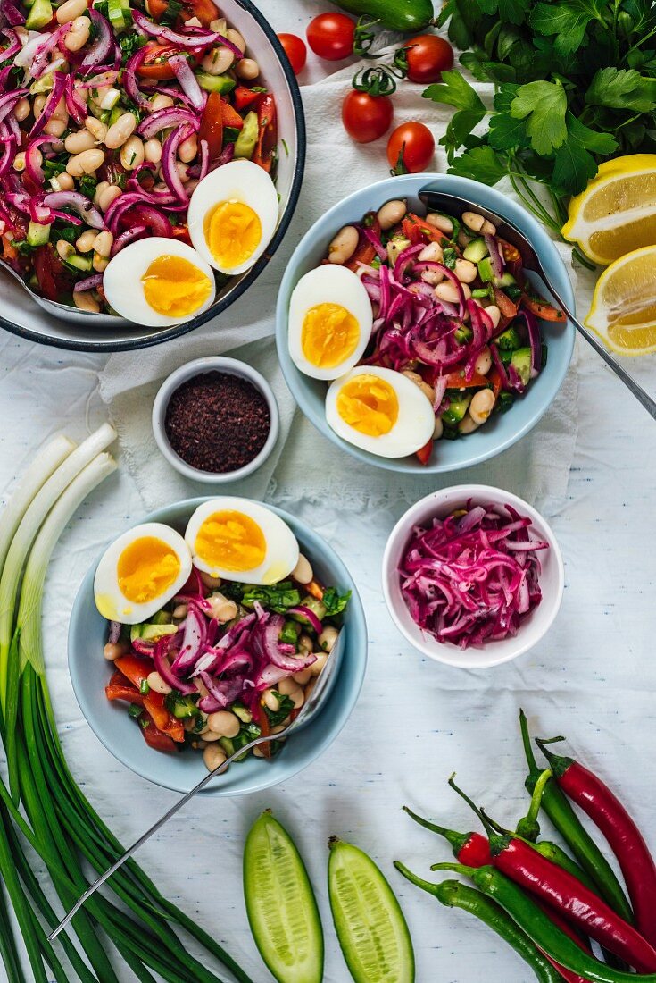 Turkish tangy bean salad known as piyaz served in bowls with halved hard-boiled eggs