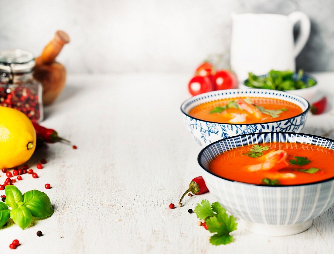 tomato soup with shrimps on rustic background