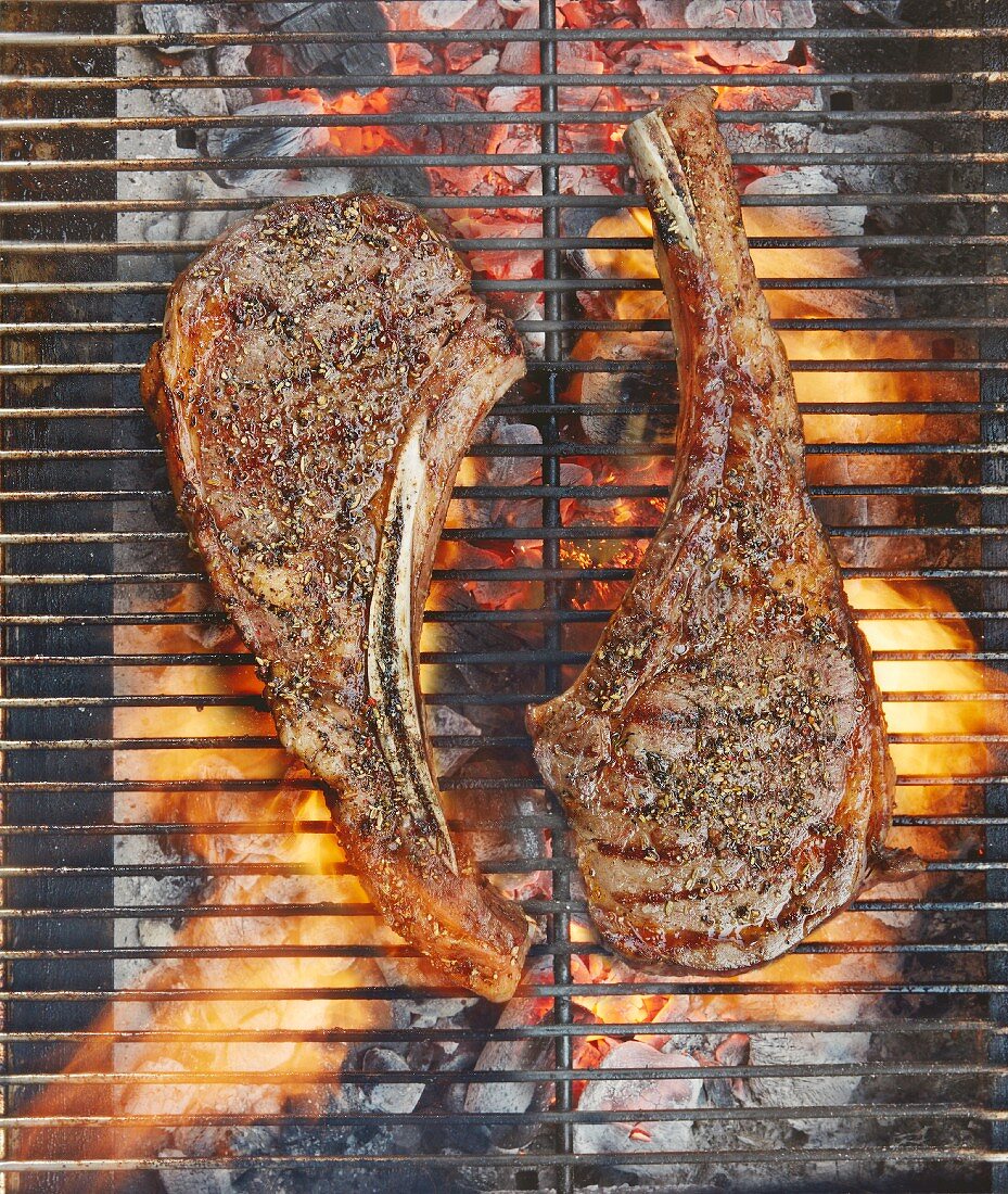 Two Galloway beef tomahawk steaks on a grill (top view)