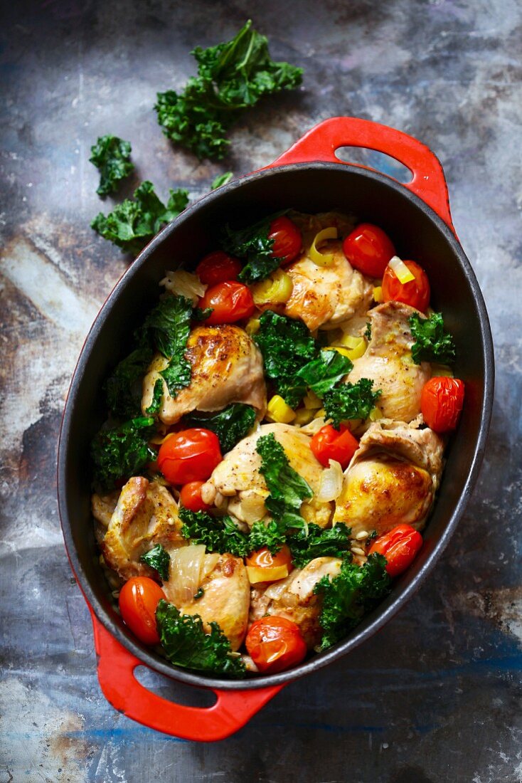 Chicken with tomato and kale in a casserole dish
