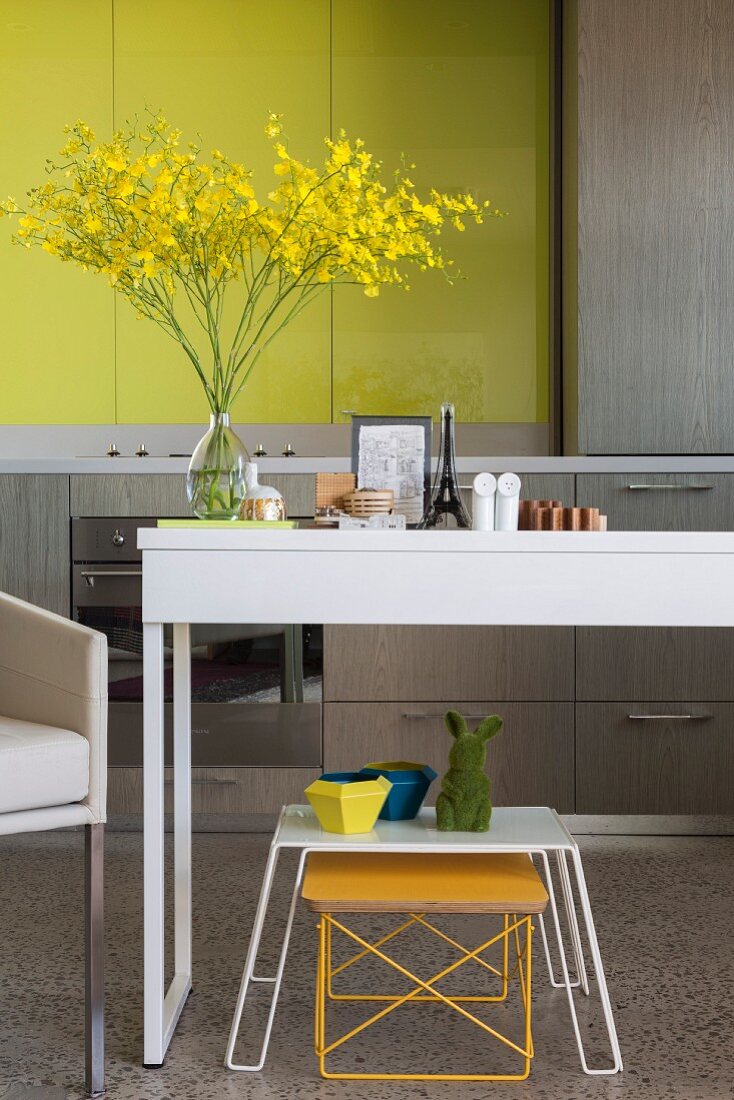 Ornaments on table in modern kitchen with yellow accents