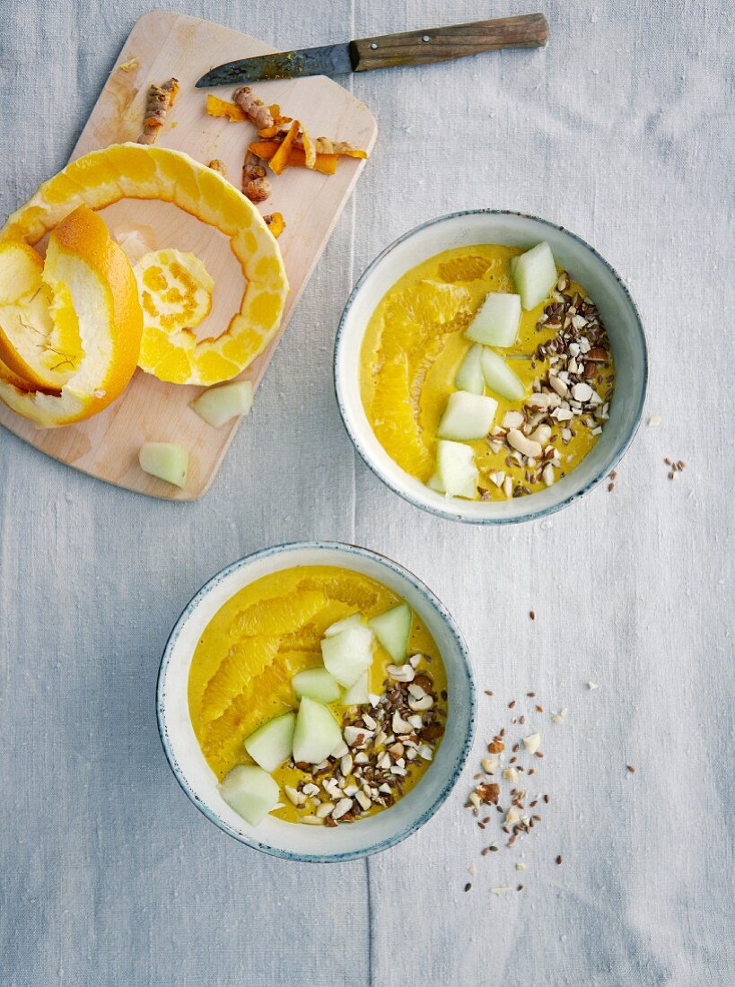 Yellow mango and banana smoothie bowls with turmeric