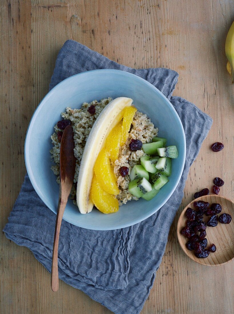 Porridge bowl with banana, kiwi and orange