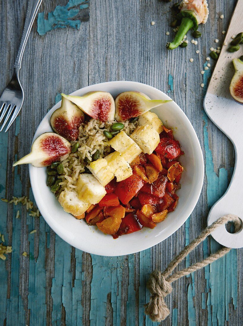 Vegetarian pistachio and rice bowl with halloumi and caramelised vegetables