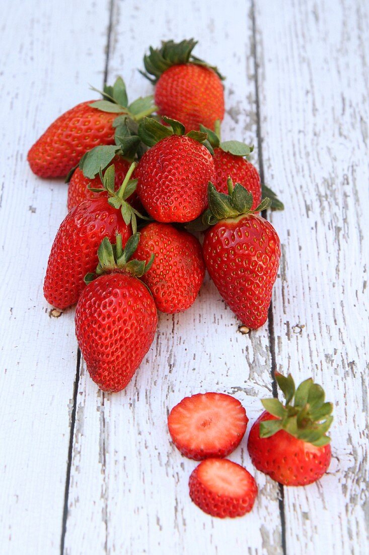 Fresh strawberries on a white wood surface