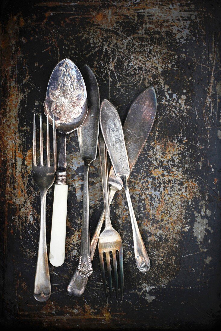 Antique cutlery on a rusty background