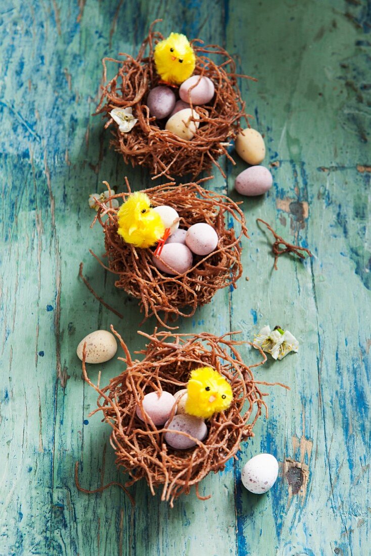 Easter nests with chocolate eggs and Easter chicks