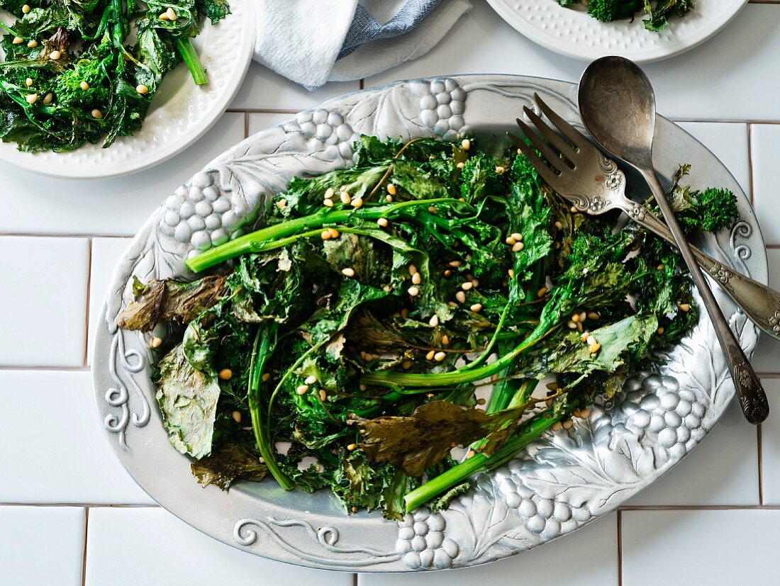 Fried broccolini with pine nuts on a vintage serving plate