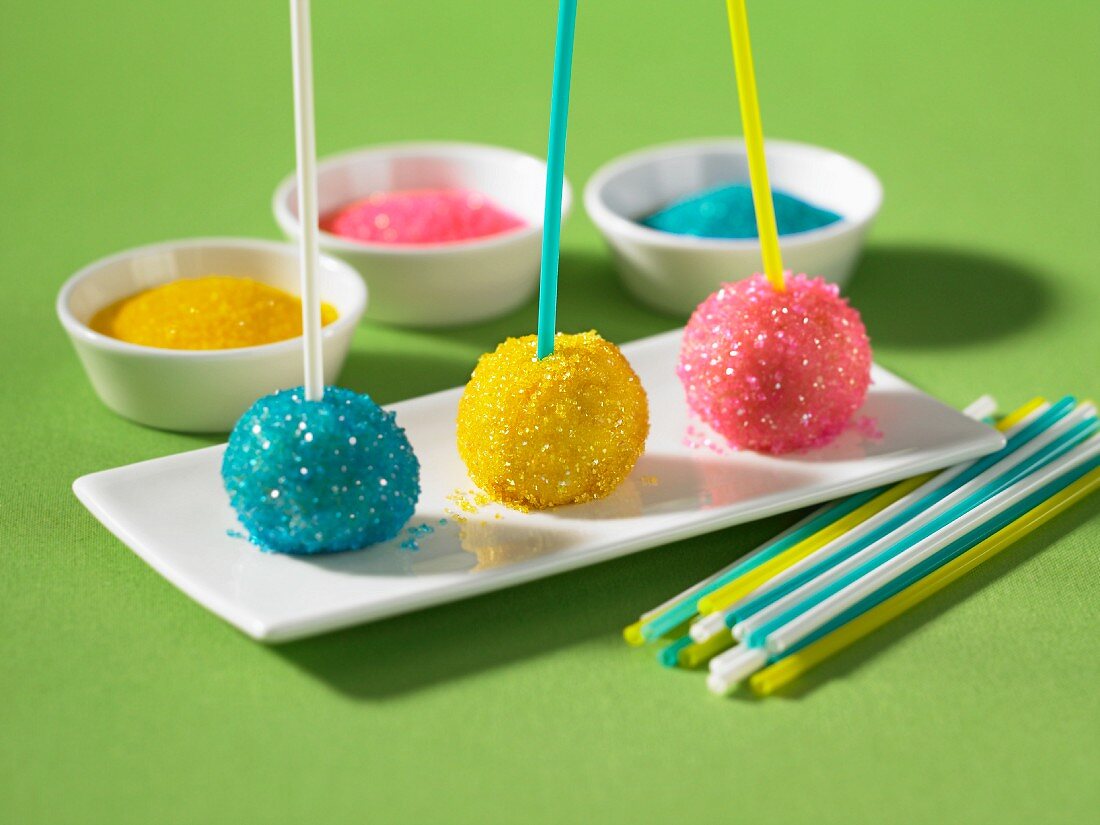Truffles on sticks decorated with brightly coloured sugar