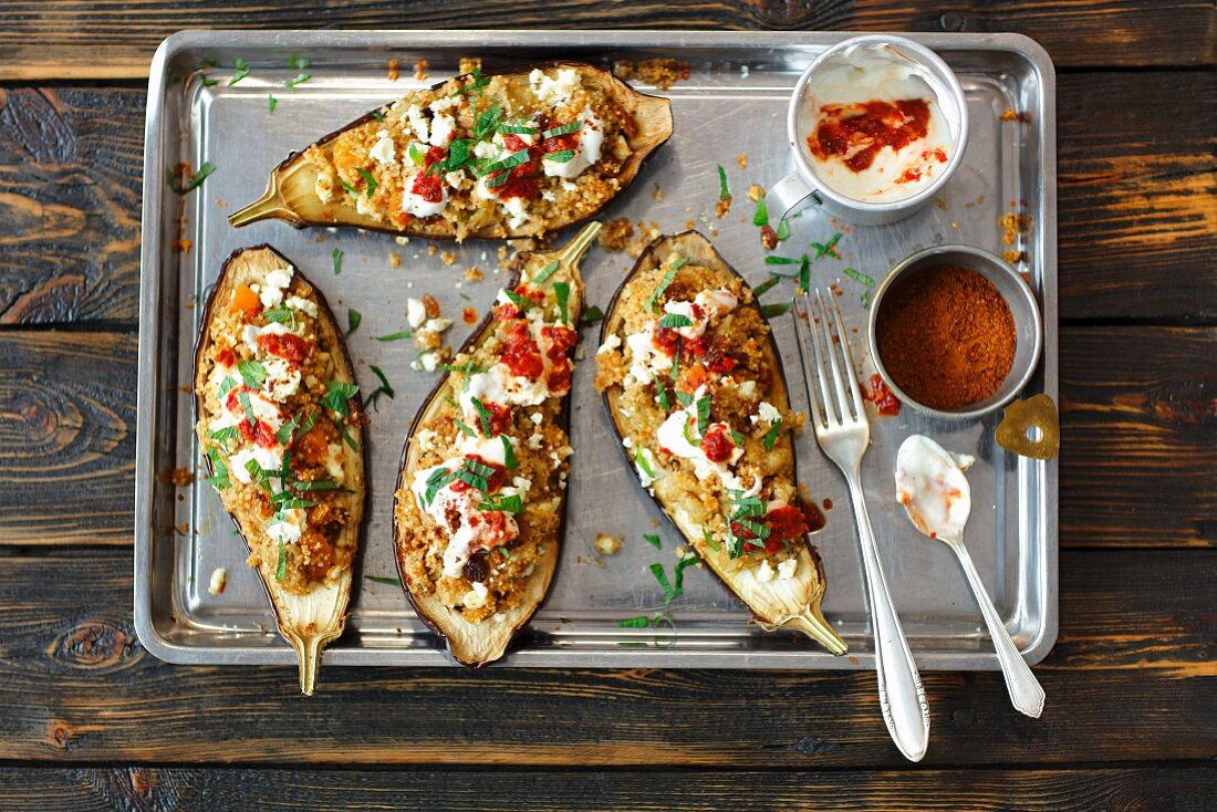 Stuffed aubergines with couscous and feta on an oven tray