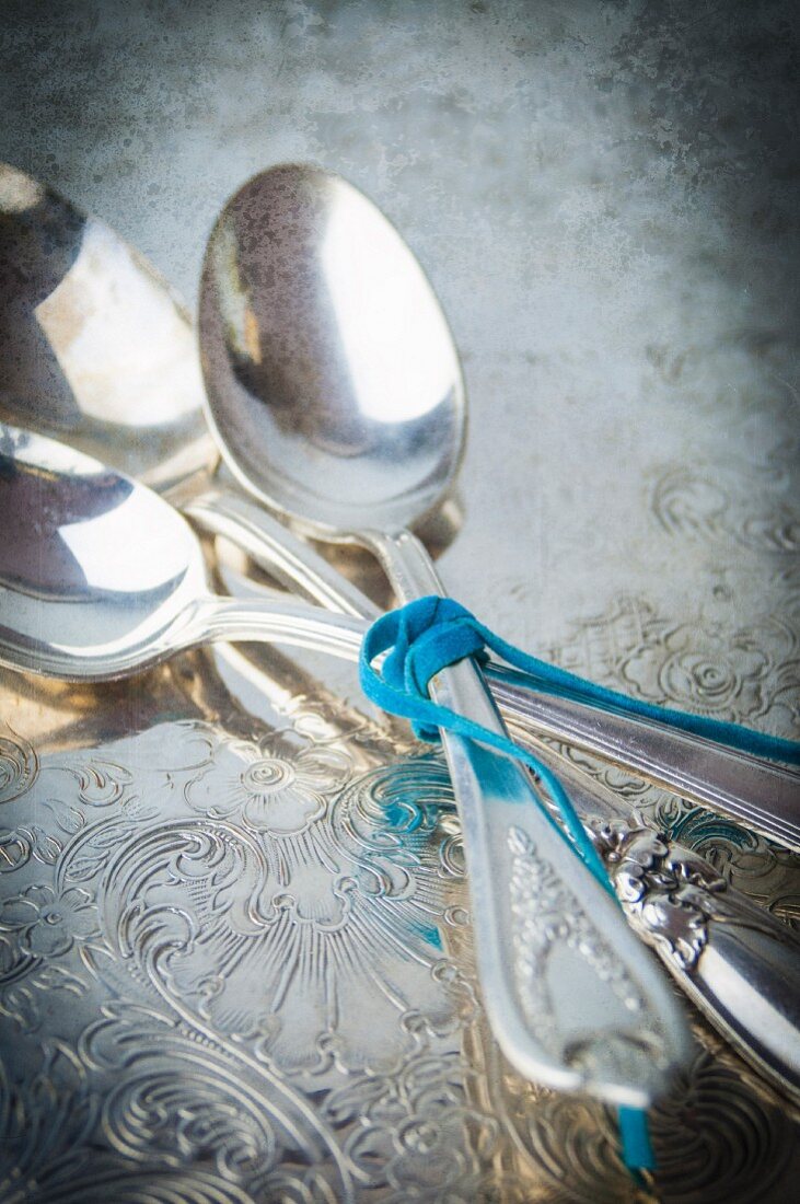 A Close Up View of Three Vintage Silver Spoons tied with Ribbon