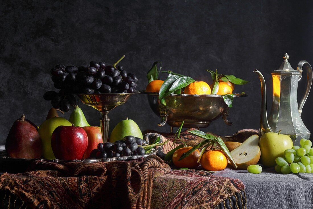 Obststillleben im Stil eines Gemäldes mit Silberkanne und Früchten in Schalen