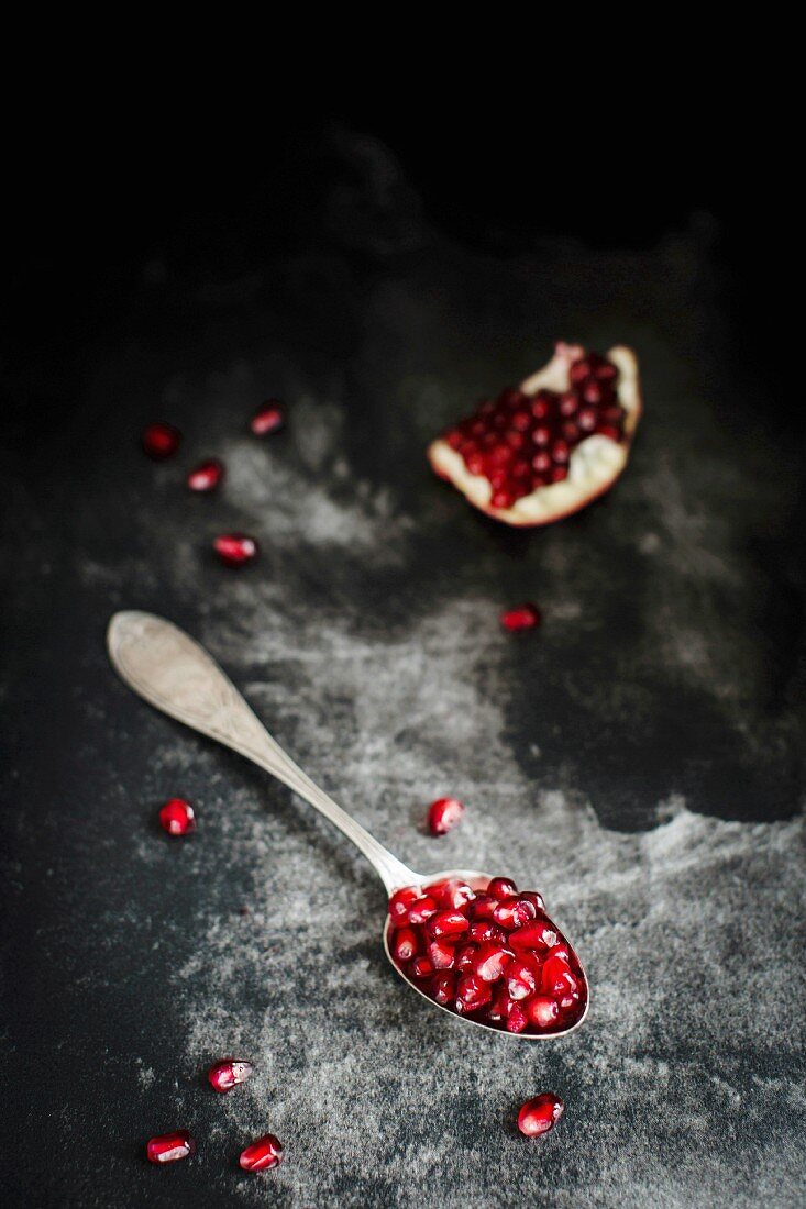 Fresh and juicy pomegranate seends on a dark background