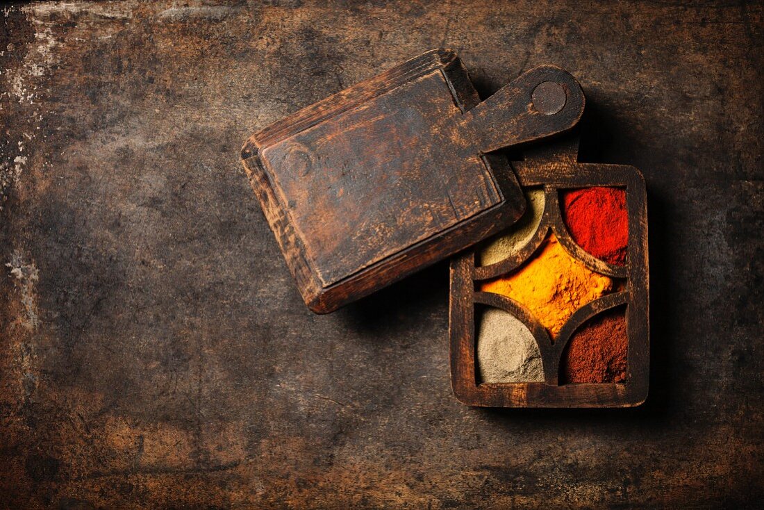 Spices selection over dark vintage table