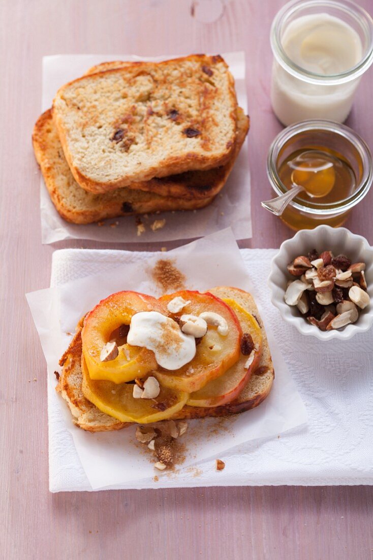 Grilled apple slices with nuts, raisins, and yogurt on cinnamon biscuits