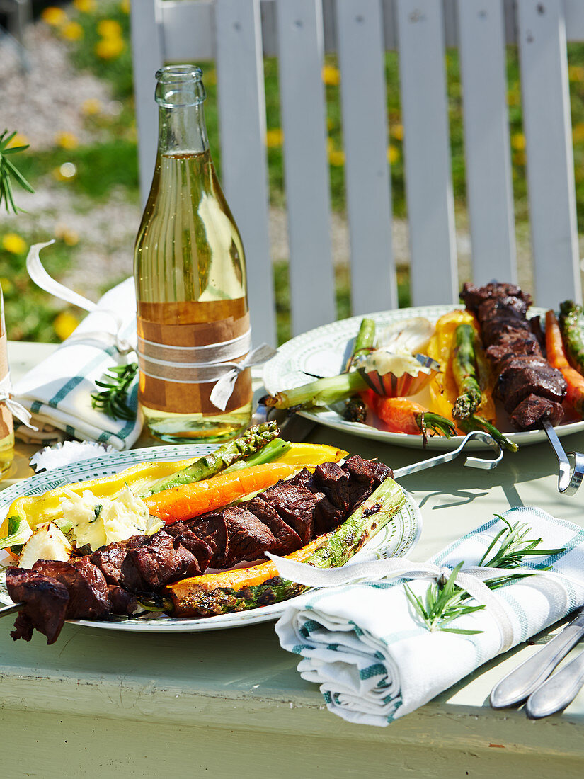 Venison skewers with grilled vegetables and herb butter