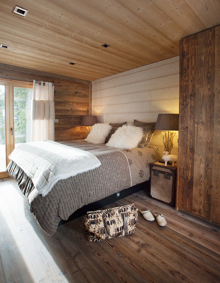Rustic bedroom in shades of brown with wooden floor