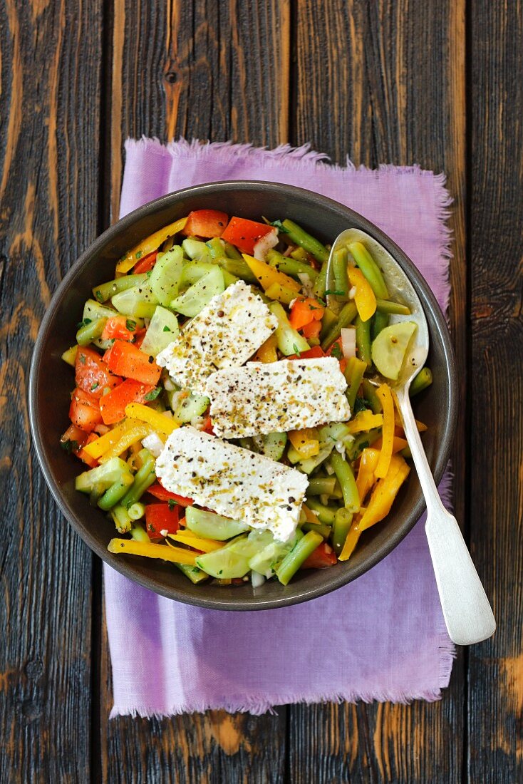 A colourful vegetable salad with fresh cheese