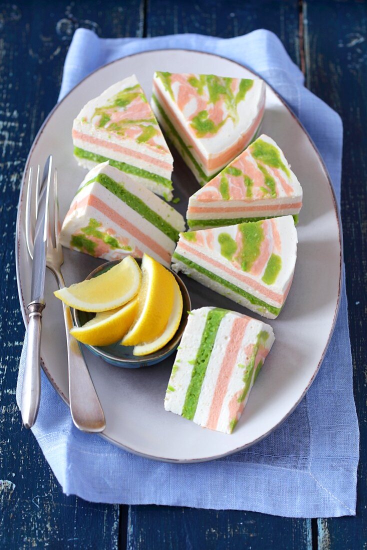 Several pieces of fresh cheese terrine with salmon and peas