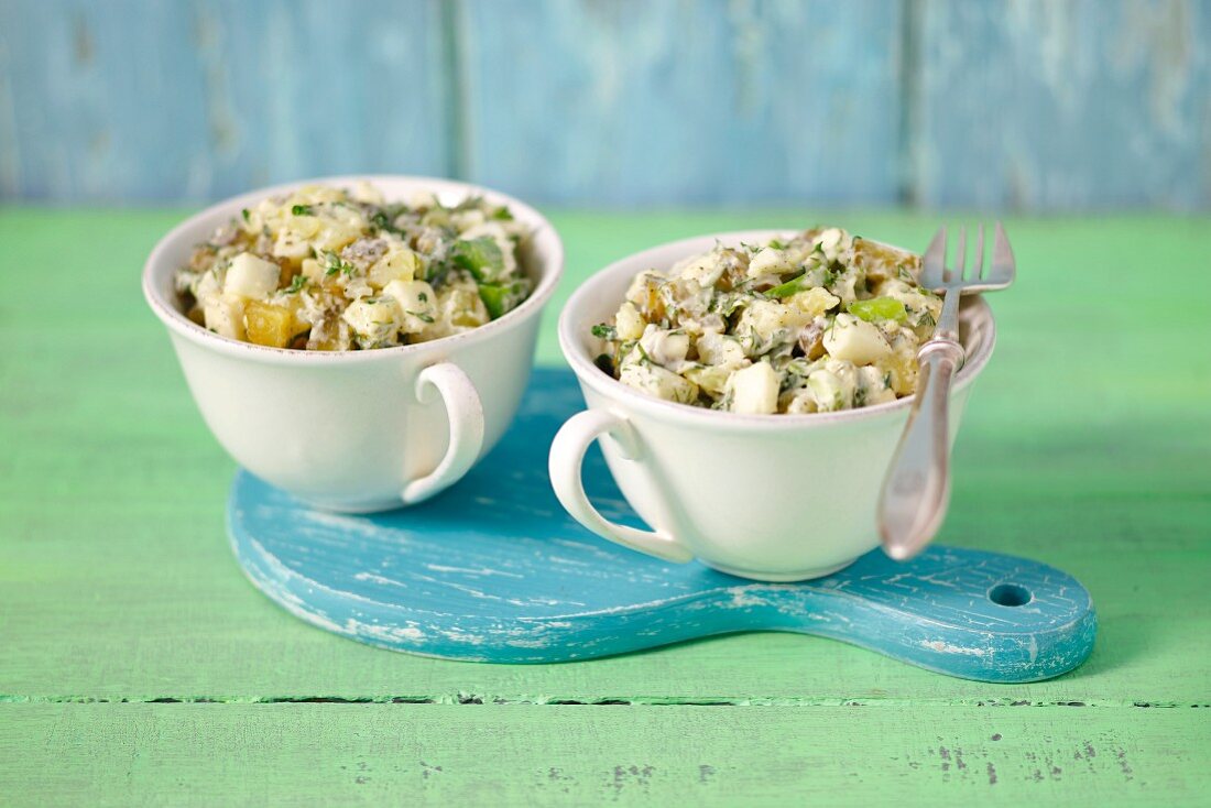Potato salad with mayonnaise and pickled gherkins, served in two cups