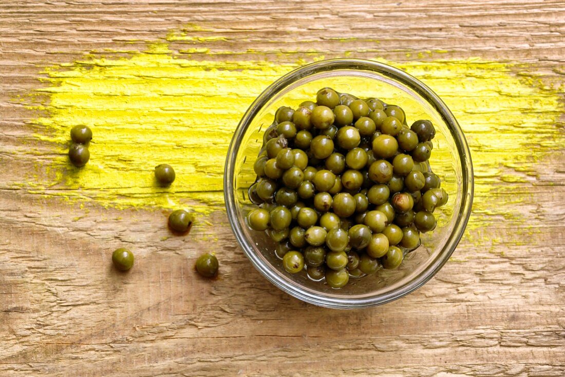 Pickled green peppercorns in a glass bowl