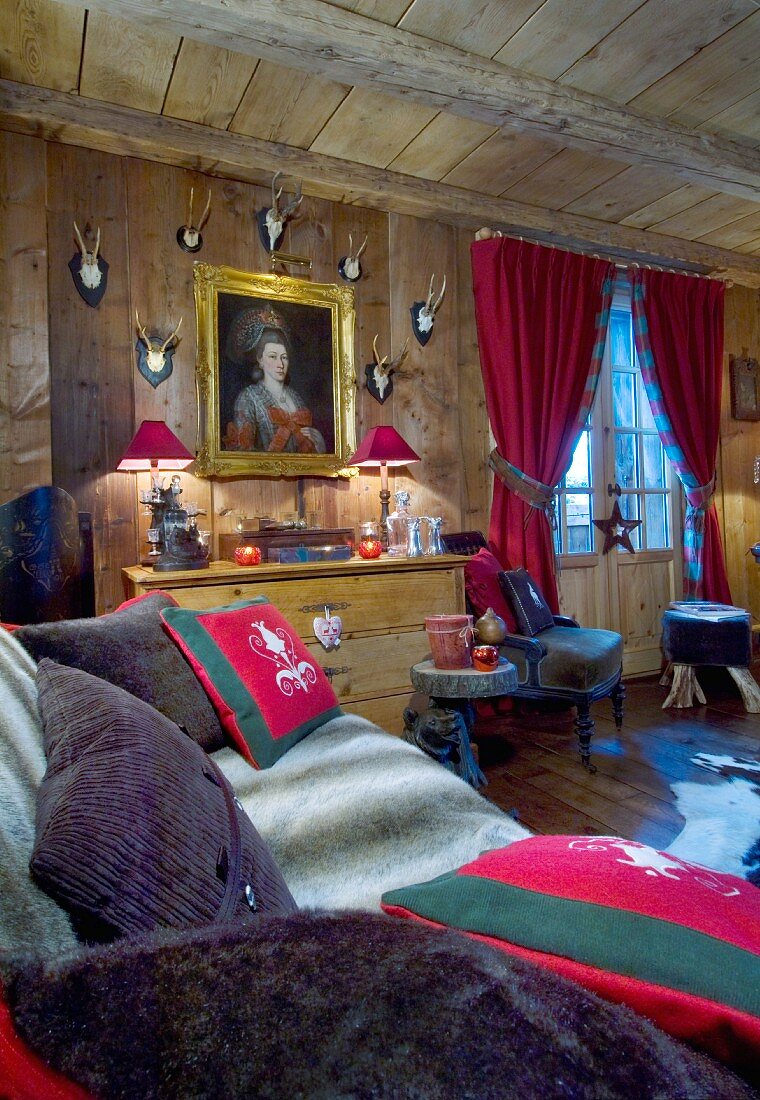 Painting and hunting trophies in comfortable chalet living room