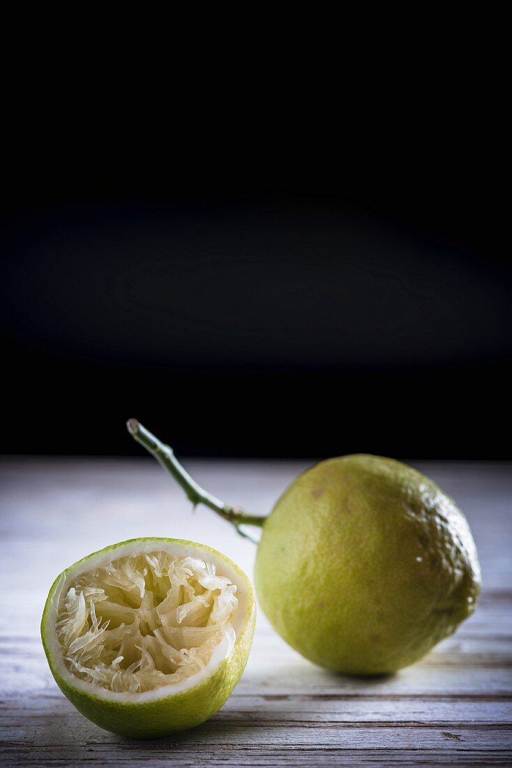 A whole lemon and a squeezed out lemon half