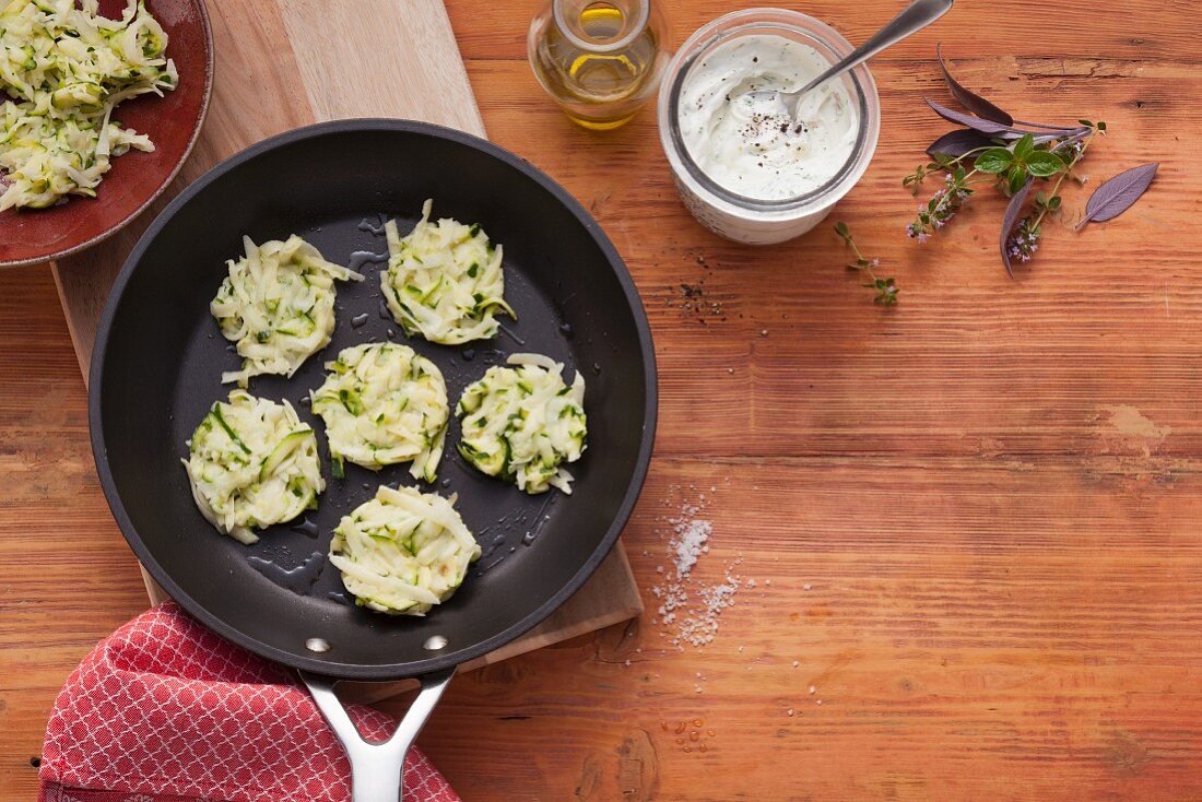 Courgette fritters in a pan