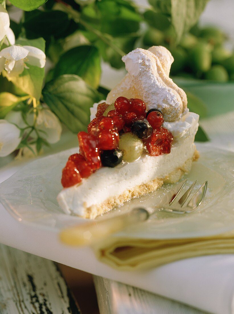 A piece of cheesecake with fruit and berries