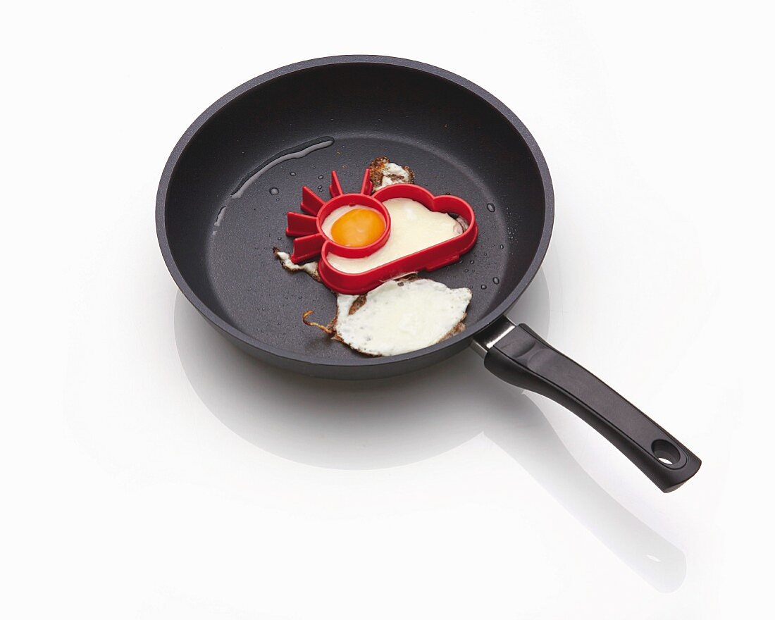 A fried egg mould in a frying pan