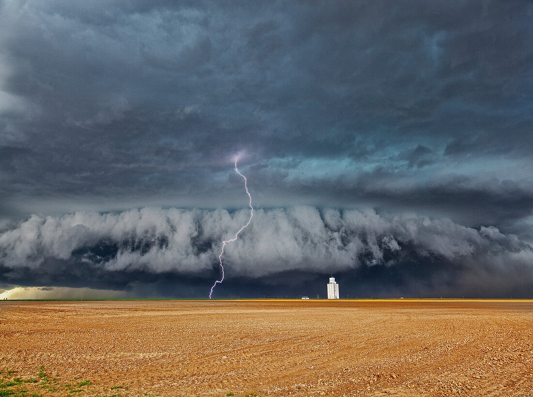 Lightning strike over wheat field, Kansas, USA