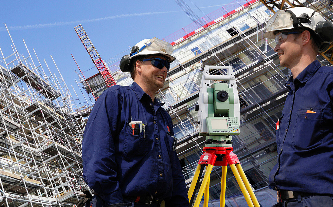 Surveyors using theodolite on site