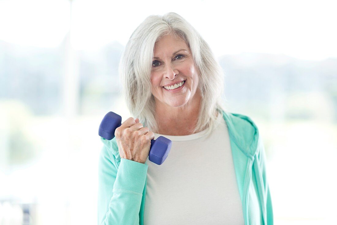 Senior woman using weights