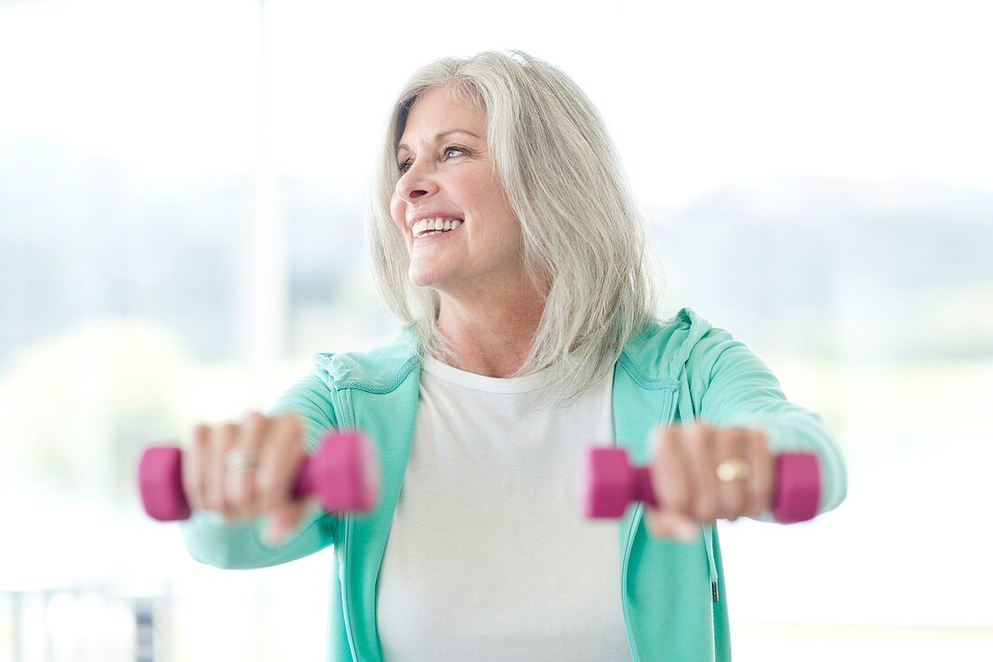 Senior woman using weights