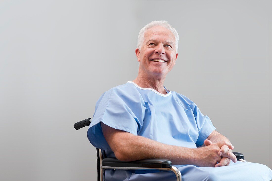 Man in hospital gown in wheelchair