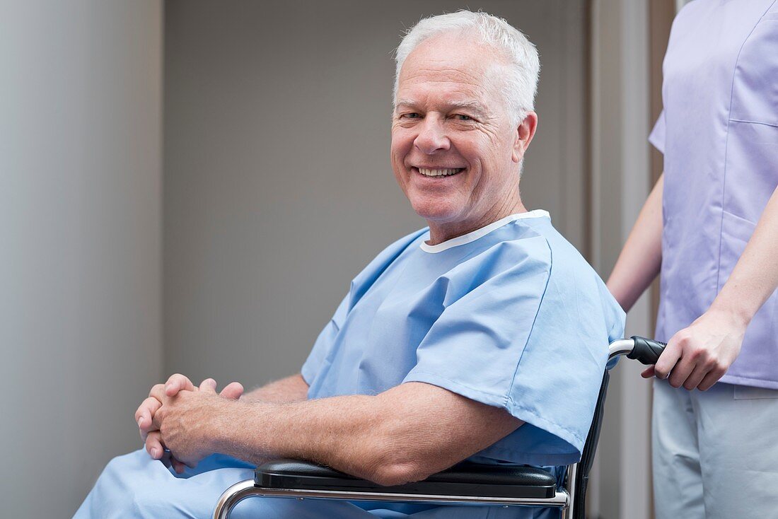 Man in hospital gown in wheelchair