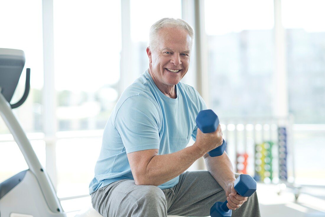 Senior man using weights